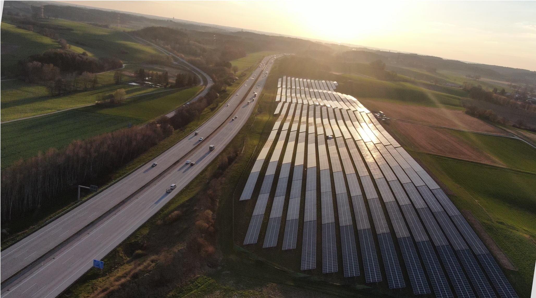 Solar panels on a field next to a highway Solar panels on a field next to a highway.